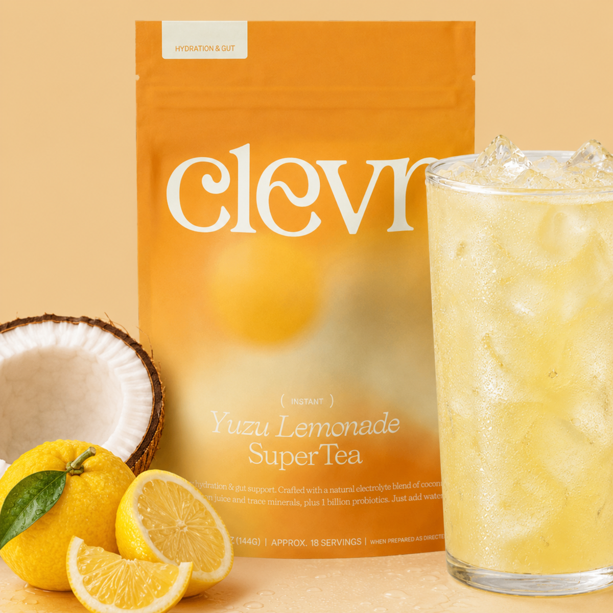 product image of clevr yuzu lemonade supertea pouch with fruit adjacent coconut and lemon and a drinking glass filled with iced lemonade